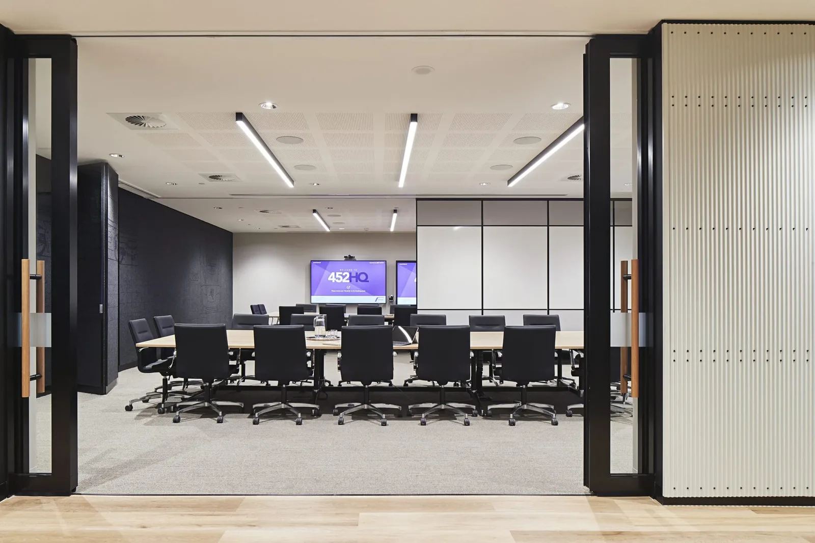 Boardroom in a commercial fit-out with a long meeting table, acoustic ceiling panels and linear lighting — the kind of space where acoustic advice is decided — Acoustic Panels Australia
