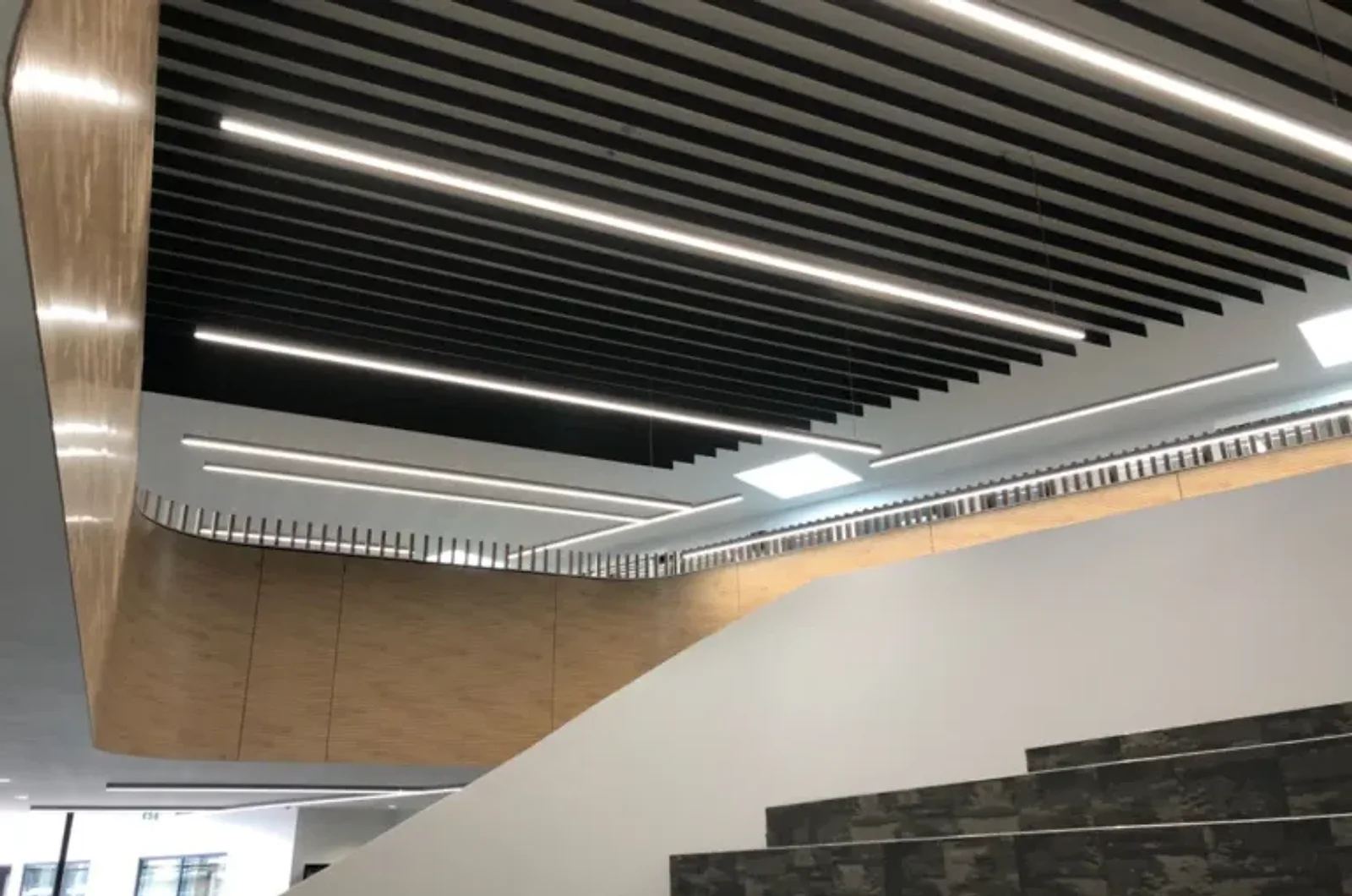 Black linear acoustic baffles on a commercial ceiling