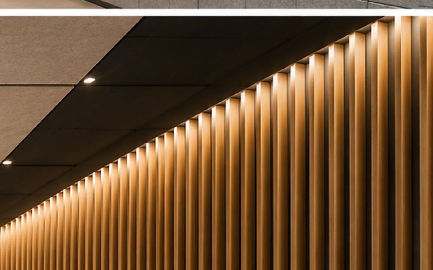 Acoustic ceiling tiles with recessed downlights above a timber slat acoustic wall in an airport terminal — Acoustic Panels Australia