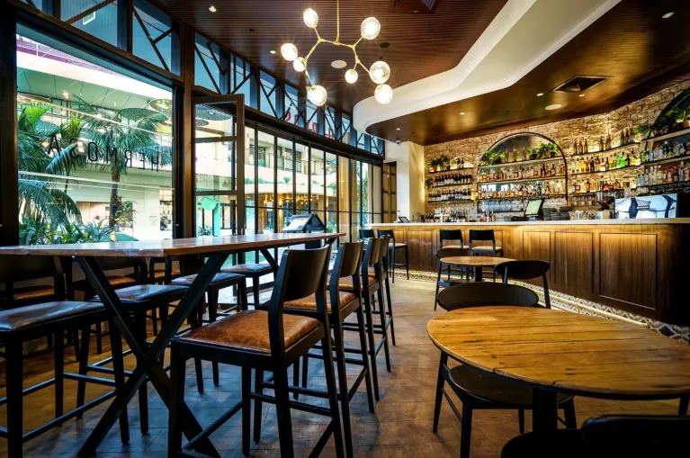 AUS Groove™ grooved timber acoustic panels lining the ceiling of a bar and dining space — Acoustic Panels Australia
