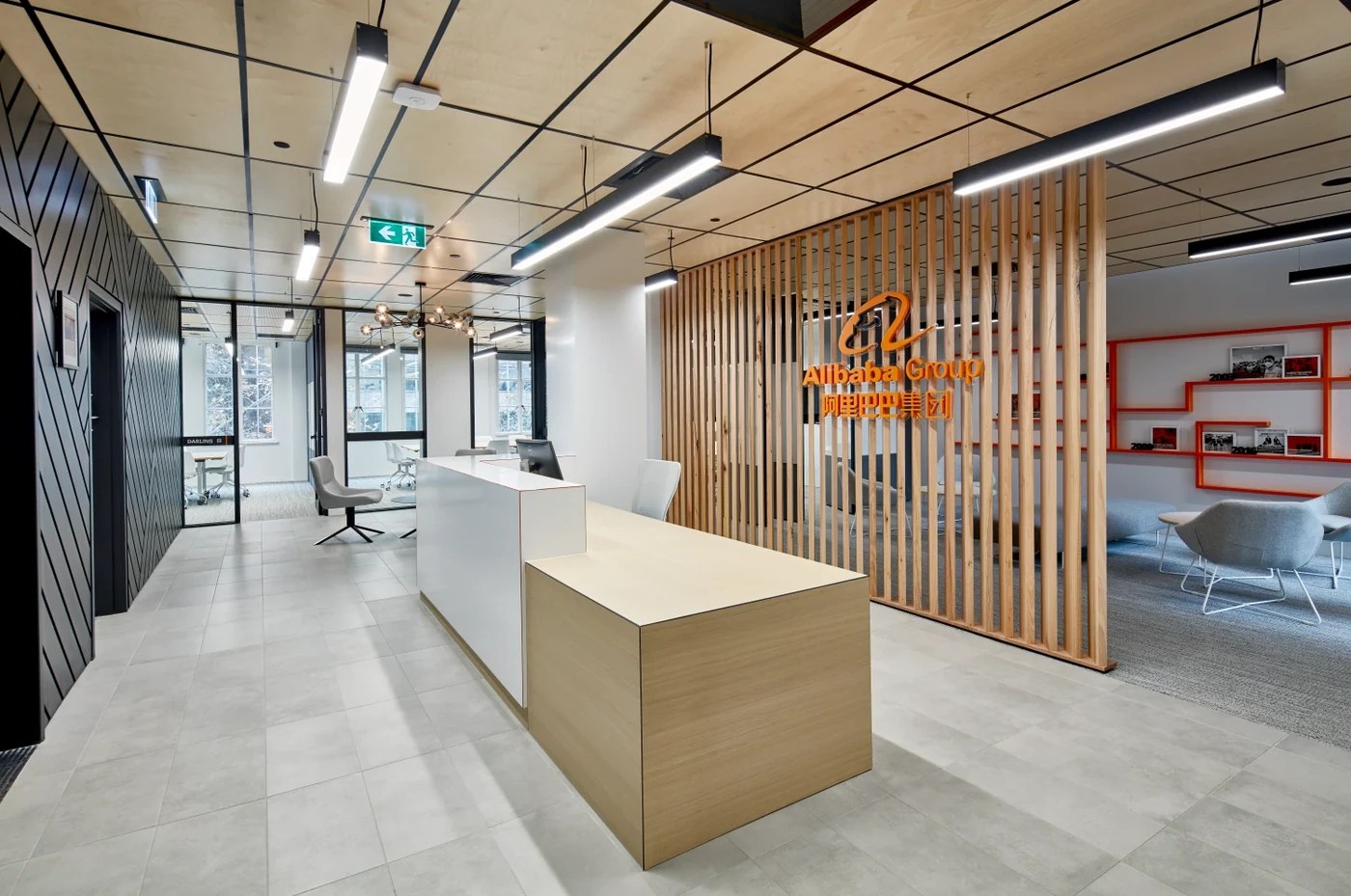 A reception area with a timber slat screen, black grid ceiling and a stone-topped counter — Acoustic Panels Australia