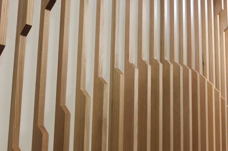 Close-up of AUS Fins™ timber fins set at varying angles and depths, showing the repeating geometric profile that gives the panel its rhythm — Acoustic Panels Australia