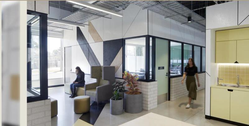 Education fit-out with a geometric acoustic feature wall and glass learning spaces by Acoustic Panels Australia