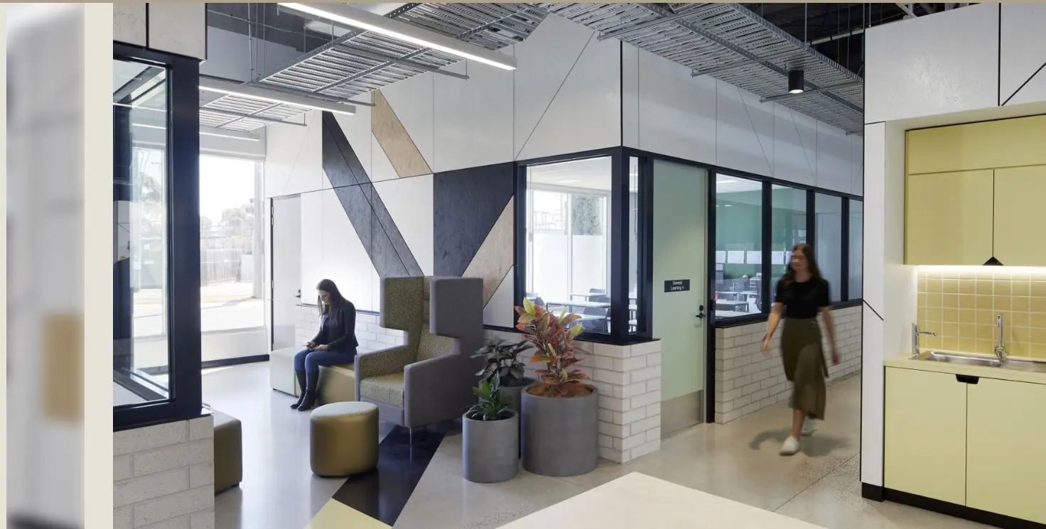 Education fit-out with a geometric acoustic feature wall and glass learning spaces by Acoustic Panels Australia