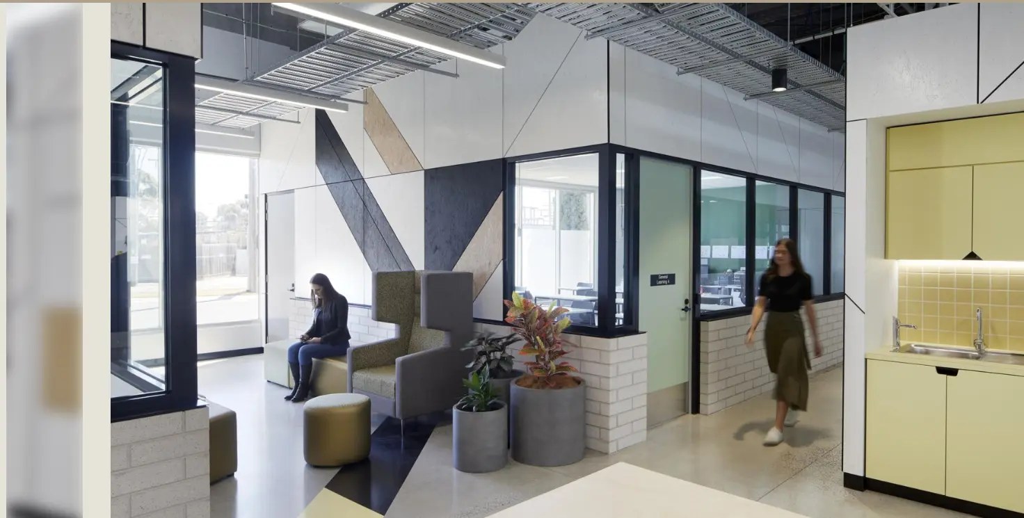 Education fit-out with a geometric acoustic feature wall and glass learning spaces by Acoustic Panels Australia